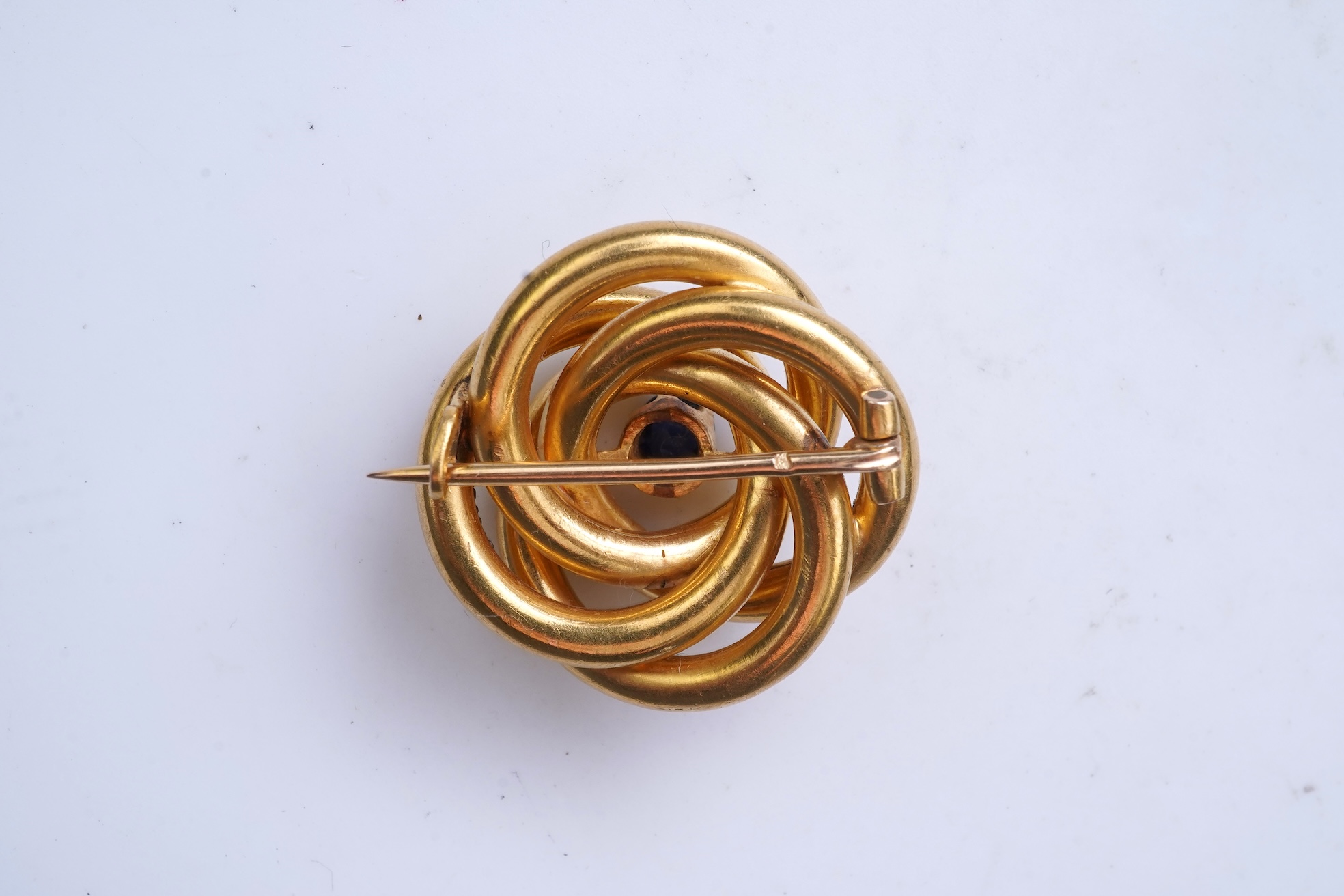 A gold and sapphire knot brooch, France, late 19th century